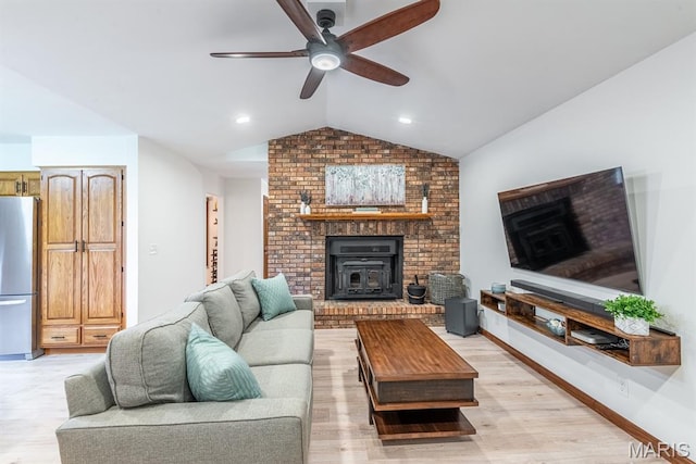 616 E Brentmoor Dr, Troy, IL 62294 - living room featuring vaulted ceiling, a ceiling fan, light wood-type flooring, and a wood stove