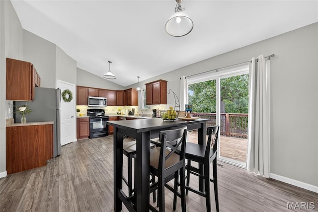 40 Valley Farms Dr, Winfield, MO 63389 - dining room featuring vaulted ceiling and light wood-style flooring