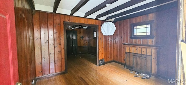 601 Chanslor, Ferguson, MO 63135 - unfurnished dining area with wood finished floors, wood walls, beamed ceiling, and a fireplace