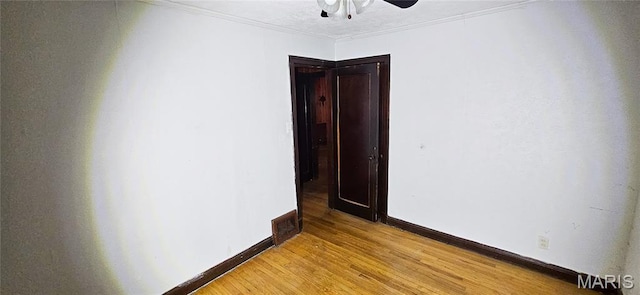601 Chanslor, Ferguson, MO 63135 - empty room featuring light wood-style flooring, a ceiling fan, and crown molding
