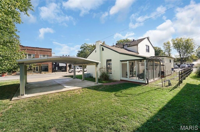 401 Elm St, Washington, MO 63090 - rear view of house with a sunroom and a lawn