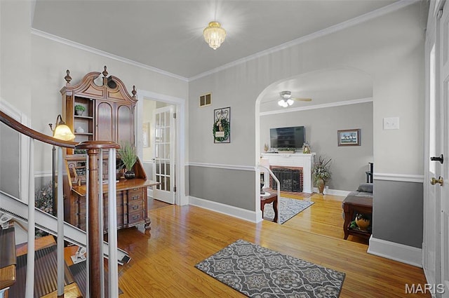401 Elm St, Washington, MO 63090 - living room with stairway, arched walkways, ceiling fan, crown molding, and wood finished floors