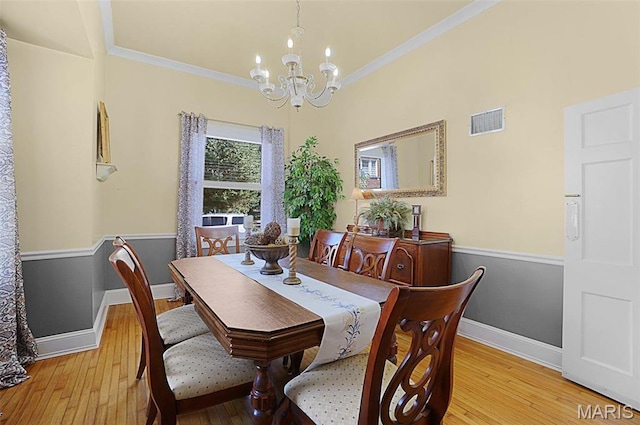401 Elm St, Washington, MO 63090 - dining area with a chandelier, light wood-type flooring, and crown molding