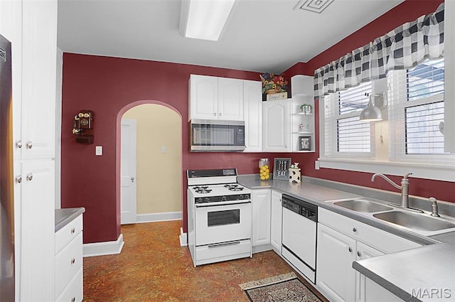 401 Elm St, Washington, MO 63090 - kitchen with white appliances, arched walkways, and white cabinets