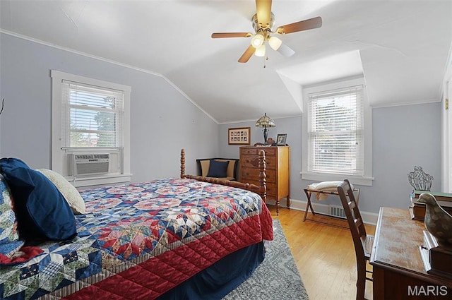401 Elm St, Washington, MO 63090 - bedroom featuring multiple windows, wood finished floors, cooling unit, lofted ceiling, and a ceiling fan