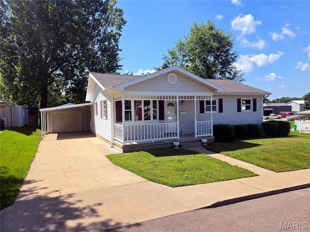 132 Linn Dr, Saint Genevieve, MO 63670 - view of front of home featuring covered porch, an outbuilding, a front yard, concrete driveway, and a garage