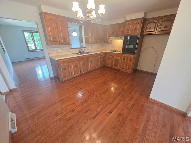 132 Linn Dr, Saint Genevieve, MO 63670 - kitchen with brown cabinets, stovetop, a baseboard radiator, and tasteful backsplash
