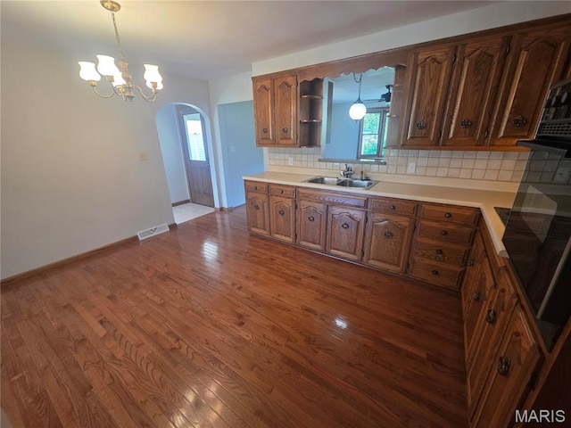 132 Linn Dr, Saint Genevieve, MO 63670 - kitchen featuring arched walkways, open shelves, dark wood-style floors, decorative backsplash, and decorative light fixtures