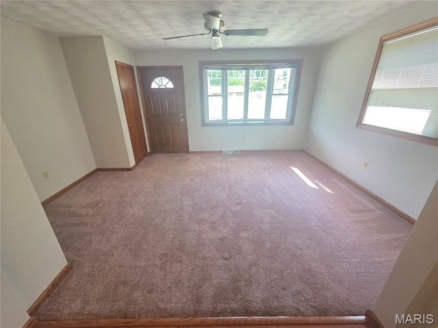 132 Linn Dr, Saint Genevieve, MO 63670 - entrance foyer with ceiling fan, light carpet, and a textured ceiling