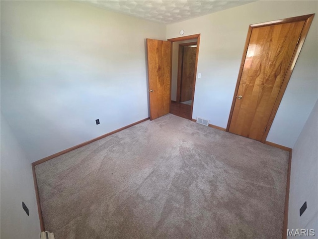 132 Linn Dr, Saint Genevieve, MO 63670 - unfurnished bedroom with carpet floors and baseboards