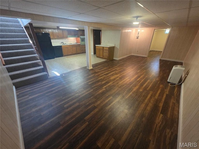 132 Linn Dr, Saint Genevieve, MO 63670 - finished below grade area featuring freestanding refrigerator, dark wood-style floors, stairs, a paneled ceiling, and wood walls