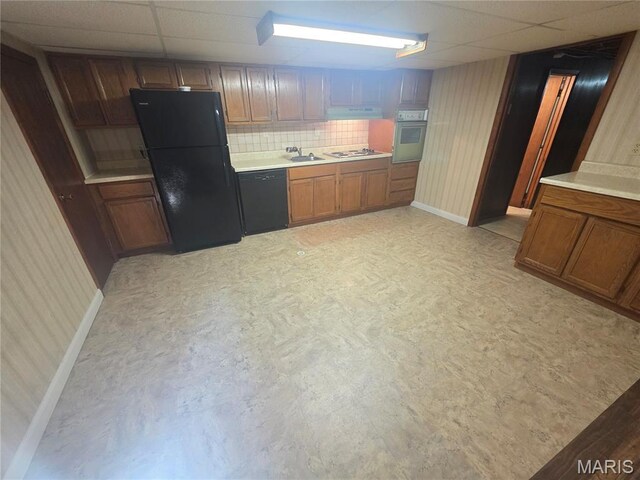 132 Linn Dr, Saint Genevieve, MO 63670 - kitchen with black appliances, a paneled ceiling, light countertops, brown cabinets, and range hood