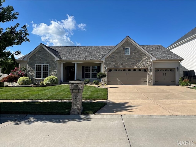 2029 Crimson Meadows Dr, Ofallon, MO 63366 - view of front of house featuring stone siding, a garage, a front yard, and concrete driveway