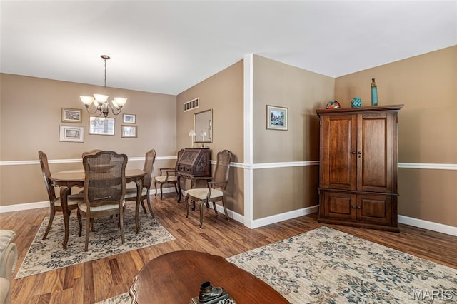 5028 Baldcypress Ct, Saint Louis, MO 63128 - dining area featuring a chandelier and wood finished floors