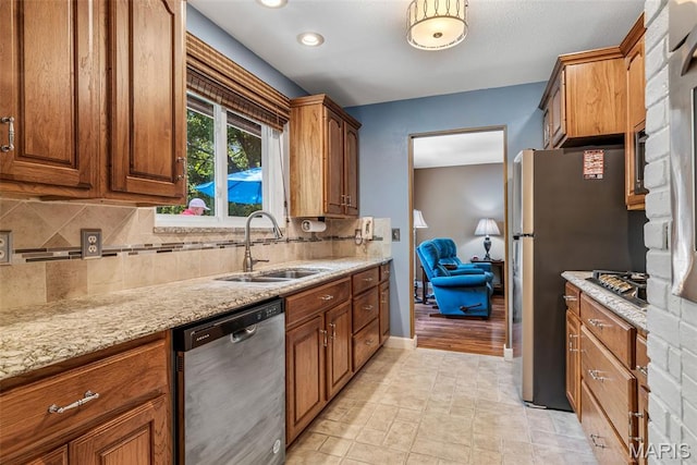 5028 Baldcypress Ct, Saint Louis, MO 63128 - kitchen with appliances with stainless steel finishes, tasteful backsplash, light stone counters, and brown cabinetry