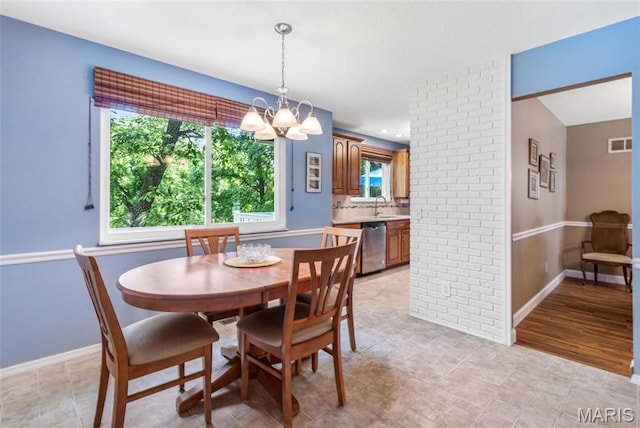 5028 Baldcypress Ct, Saint Louis, MO 63128 - dining room featuring a chandelier and plenty of natural light