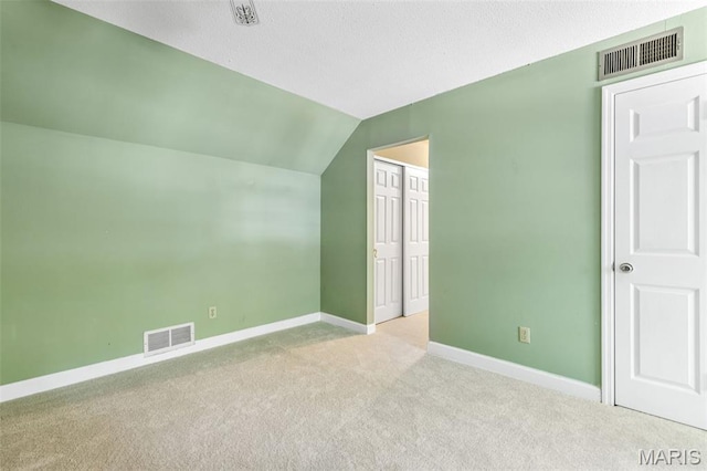 5028 Baldcypress Ct, Saint Louis, MO 63128 - additional living space featuring carpet flooring, vaulted ceiling, and a textured ceiling