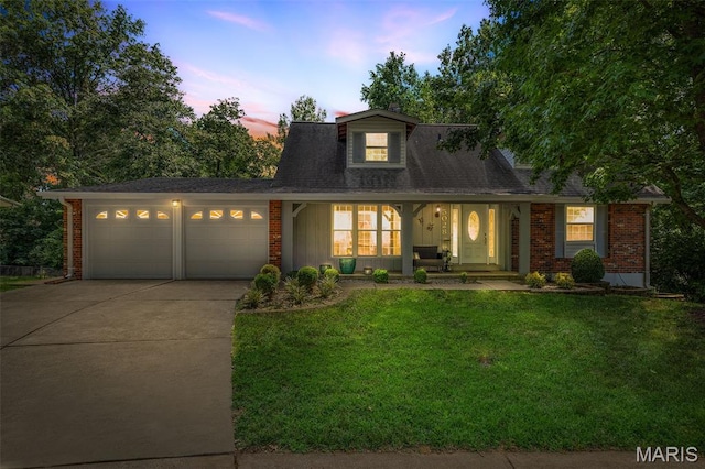 5028 Baldcypress Ct, Saint Louis, MO 63128 - view of front of house with driveway, an attached garage, brick siding, and a lawn