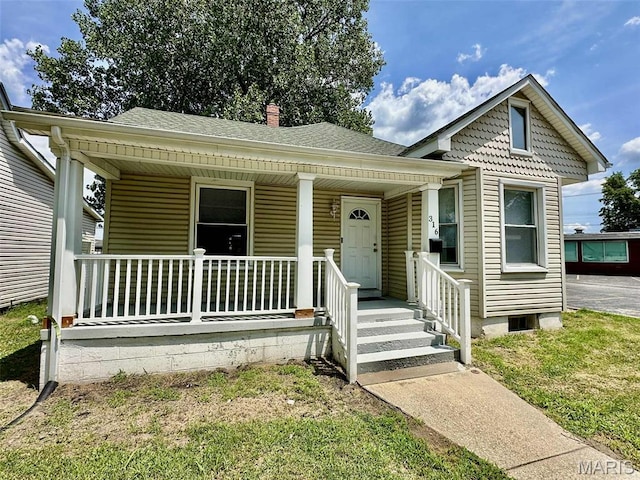 316 Church St, East Alton, IL 62024 - view of front of house with covered porch, a chimney, and roof with shingles