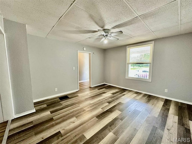 316 Church St, East Alton, IL 62024 - unfurnished room with a drop ceiling, a ceiling fan, and wood finished floors