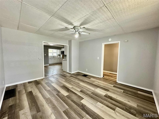 316 Church St, East Alton, IL 62024 - spare room featuring a drop ceiling, ceiling fan, and wood finished floors