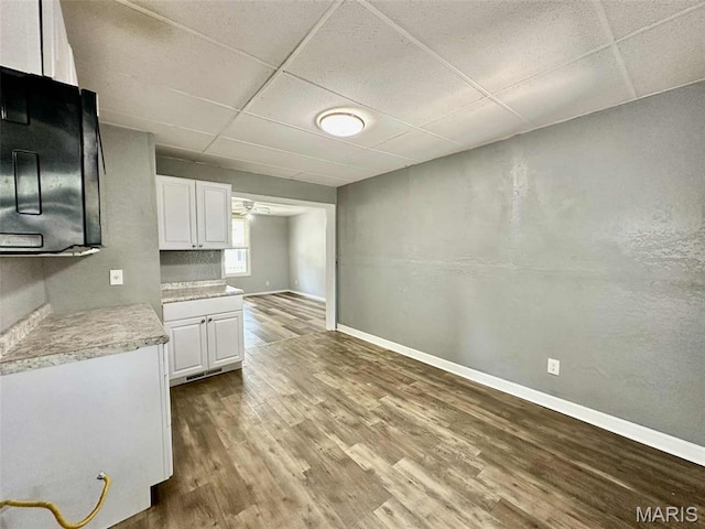 316 Church St, East Alton, IL 62024 - kitchen featuring a drop ceiling, wood finished floors, white cabinets, and light countertops