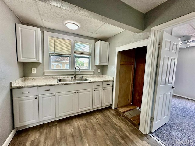 316 Church St, East Alton, IL 62024 - kitchen featuring white cabinetry, wood finished floors, light countertops, and a ceiling fan