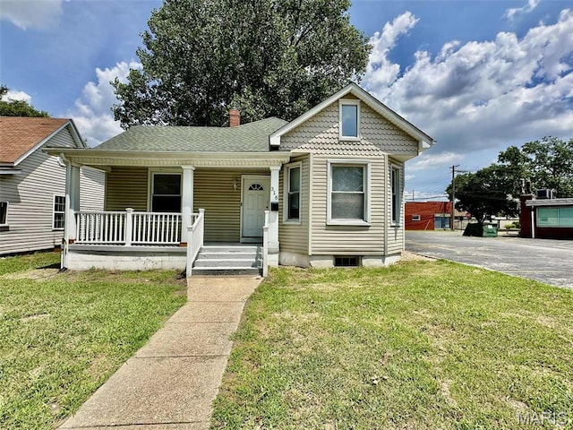 316 Church St, East Alton, IL 62024 - view of front of home featuring a porch, a front lawn, and a chimney
