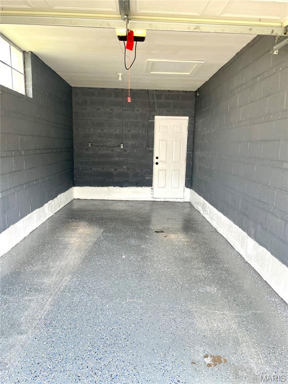 9264 Bellefontaine Rd, Bellefontaine Nghbrs, MO 63137 - garage with a garage door opener and concrete block wall