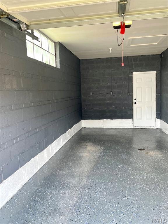 9264 Bellefontaine Rd, Bellefontaine Nghbrs, MO 63137 - garage with a garage door opener and concrete block wall
