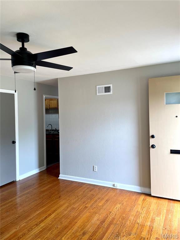 9264 Bellefontaine Rd, Bellefontaine Nghbrs, MO 63137 - unfurnished room featuring a ceiling fan and wood finished floors