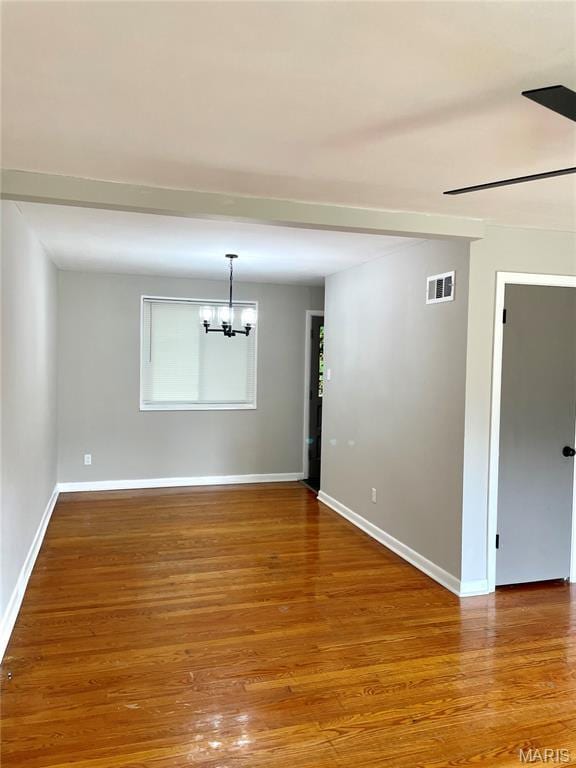 9264 Bellefontaine Rd, Bellefontaine Nghbrs, MO 63137 - unfurnished room featuring a chandelier and wood finished floors