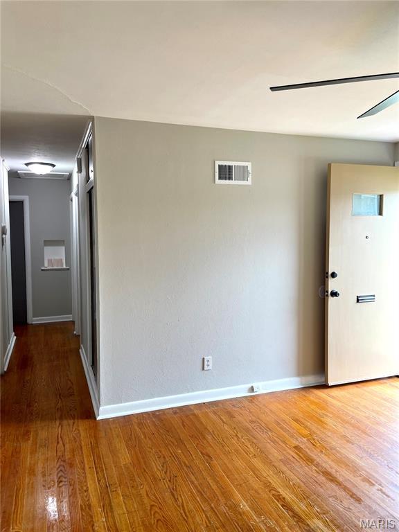 9264 Bellefontaine Rd, Bellefontaine Nghbrs, MO 63137 - hallway featuring wood finished floors and baseboards