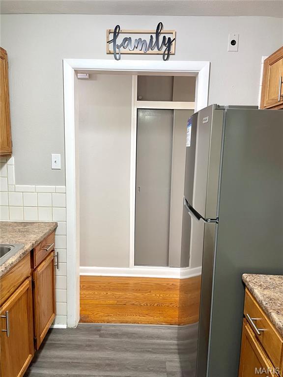 9264 Bellefontaine Rd, Bellefontaine Nghbrs, MO 63137 - bathroom featuring wood finished floors and an enclosed shower