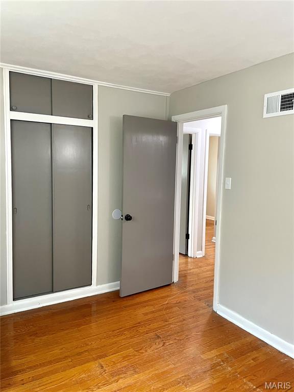 9264 Bellefontaine Rd, Bellefontaine Nghbrs, MO 63137 - unfurnished bedroom featuring a closet and light wood-type flooring