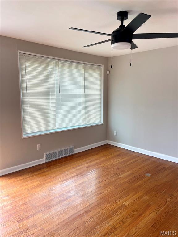 9264 Bellefontaine Rd, Bellefontaine Nghbrs, MO 63137 - spare room featuring a ceiling fan and wood finished floors
