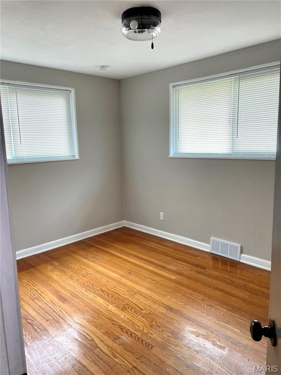 9264 Bellefontaine Rd, Bellefontaine Nghbrs, MO 63137 - unfurnished room featuring wood finished floors