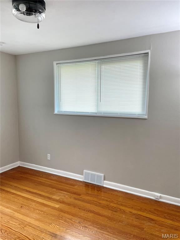 9264 Bellefontaine Rd, Bellefontaine Nghbrs, MO 63137 - spare room featuring baseboards and wood finished floors