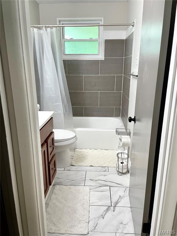 9264 Bellefontaine Rd, Bellefontaine Nghbrs, MO 63137 - bathroom with vanity, marble finish floors, and shower / bath combo