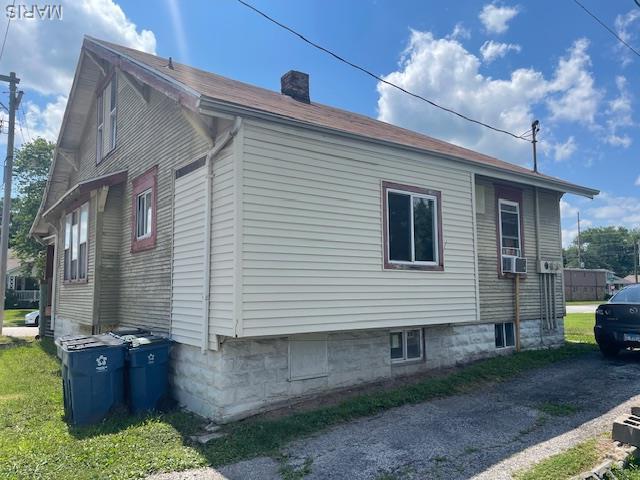 116 N Hesperia St Unit 1, Collinsville, IL 62234 - view of side of home featuring cooling unit and a chimney