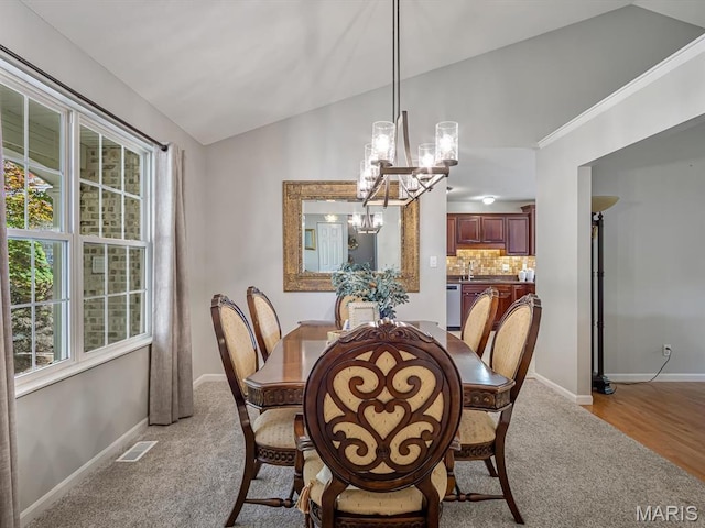 22 Foxmoor Dr, Maryville, IL 62062 - dining area featuring a chandelier, light colored carpet, and vaulted ceiling