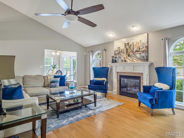 22 Foxmoor Dr, Maryville, IL 62062 - living room with ceiling fan, wood finished floors, a tile fireplace, and high vaulted ceiling