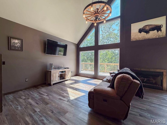 10185 Springer Dr, Bonne Terre, MO 63628 - living room featuring dark wood-style floors, a chandelier, high vaulted ceiling, and a fireplace