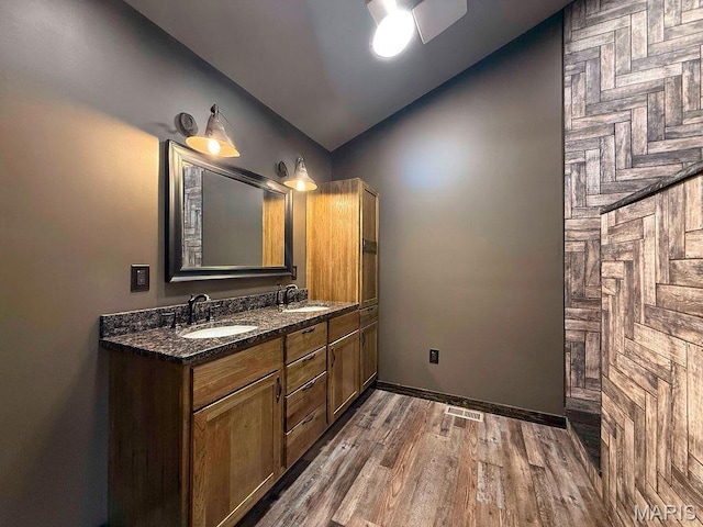 10185 Springer Dr, Bonne Terre, MO 63628 - bathroom featuring vaulted ceiling, double vanity, wood finished floors, and ceiling fan