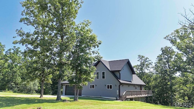 10185 Springer Dr, Bonne Terre, MO 63628 - view of side of home with a lawn, a wooden deck, and a garage