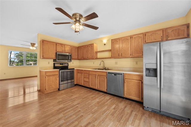 221 James St, Bethalto, IL 62010 - kitchen featuring appliances with stainless steel finishes, ceiling fan, light wood-type flooring, and light countertops