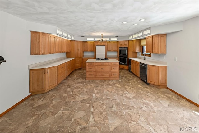 46 Coronation Dr, Millstadt, IL 62260 - kitchen with black appliances, light countertops, a center island, brown cabinetry, and a chandelier