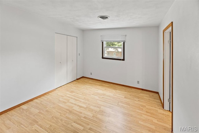 46 Coronation Dr, Millstadt, IL 62260 - unfurnished bedroom with light wood-type flooring and a closet