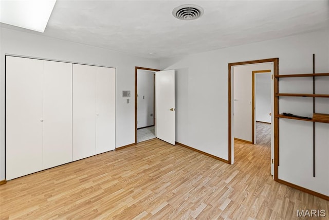 46 Coronation Dr, Millstadt, IL 62260 - unfurnished bedroom featuring light wood-style floors and a closet