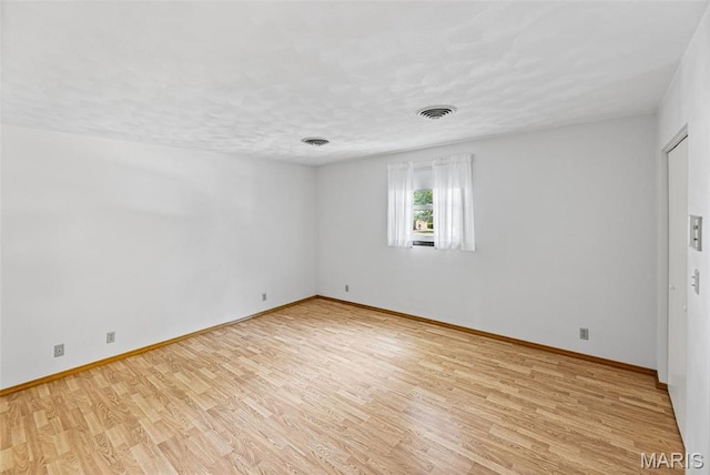 46 Coronation Dr, Millstadt, IL 62260 - empty room featuring light wood-style floors and a textured ceiling